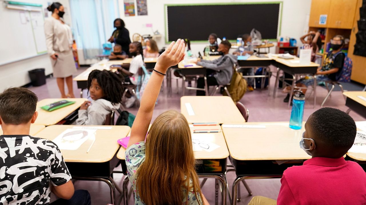 Students sit in a classroom 