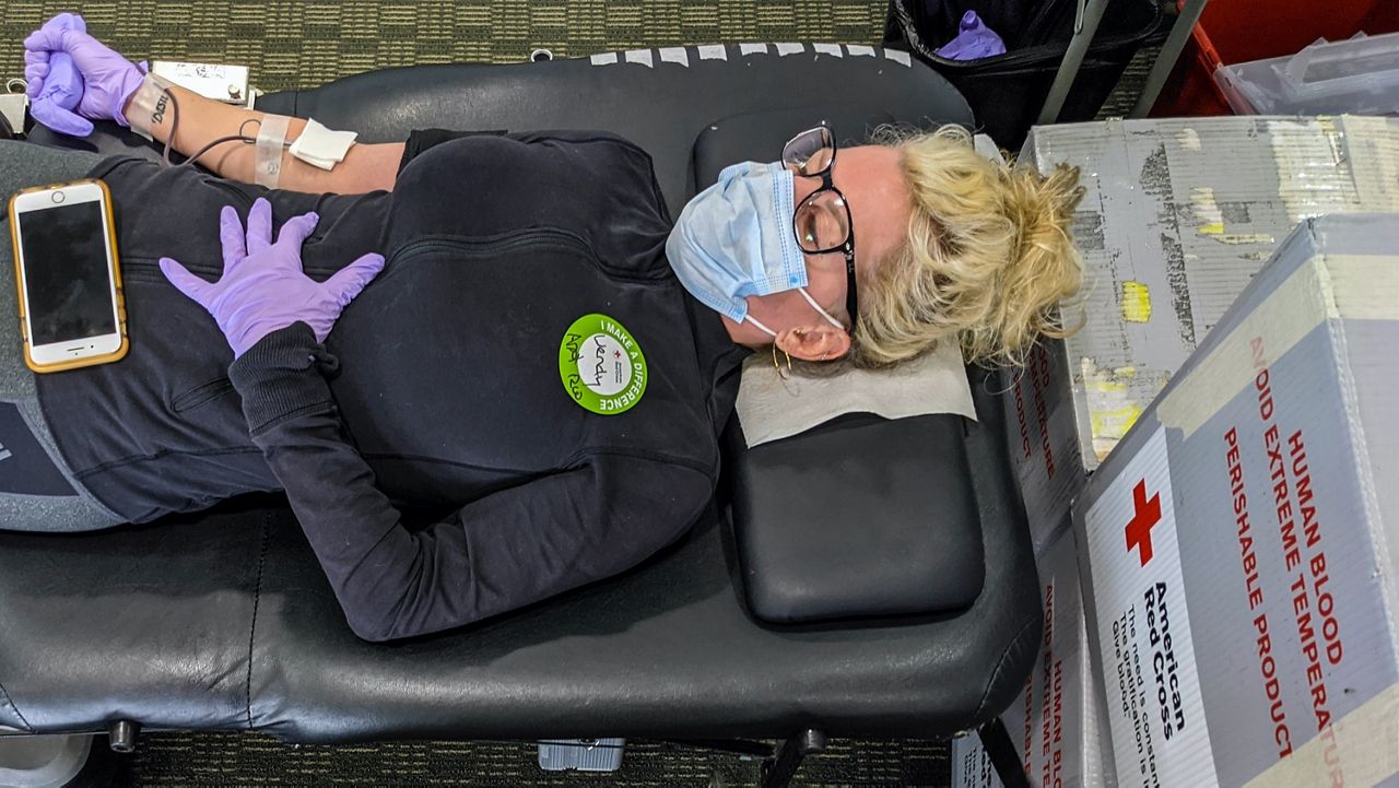 A woman donates blood at an American Red Cross donation center in Santa Monica in this March 2020 file photo. (AP Photo/Damian Dovarganes)
