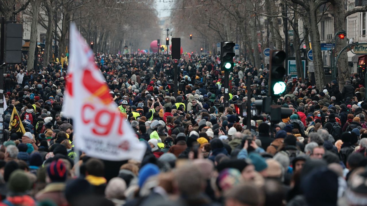 Protestors march during a demonstration against pension changes, Thursday, Jan. 19, 2023 in Paris. Workers in many French cities took to the streets Thursday to reject proposed pension changes that would push back the retirement age, amid a day of nationwide strikes and protests seen as a major test for Emmanuel Macron and his presidency. (AP Photo/Lewis Joly)
