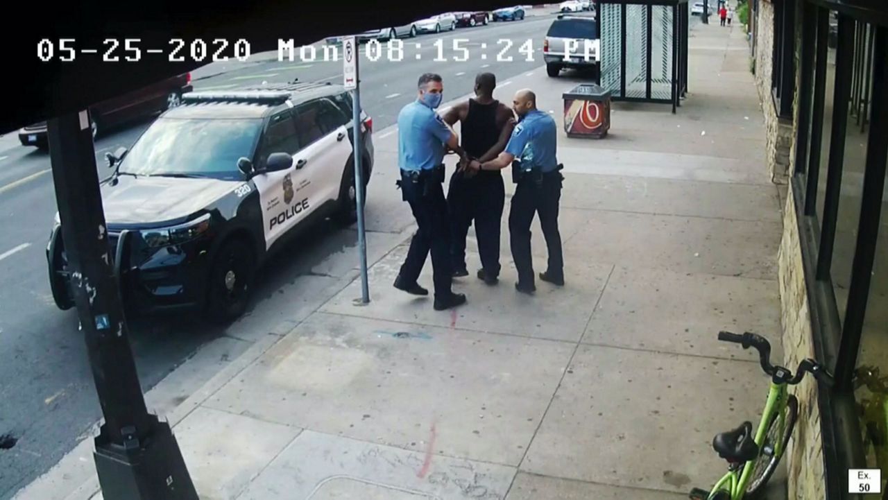This image from video shows Minneapolis Police Officers Thomas Lane, left and J. Alexander Kueng, right, escorting George Floyd, center, to a police vehicle outside Cup Foods in Minneapolis, on May 25, 2020. (Court TV via AP, Pool, File)