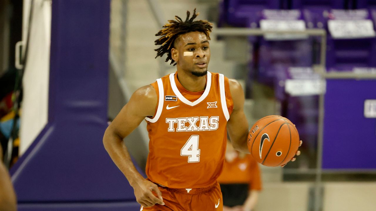 Texas forward Greg Brown (4) dribbles the ball up the court against TCU during the first half of an NCAA college basketball game in Fort Worth, Texas, Sunday, March 7, 2021. (AP Photo/Michael Ainsworth)