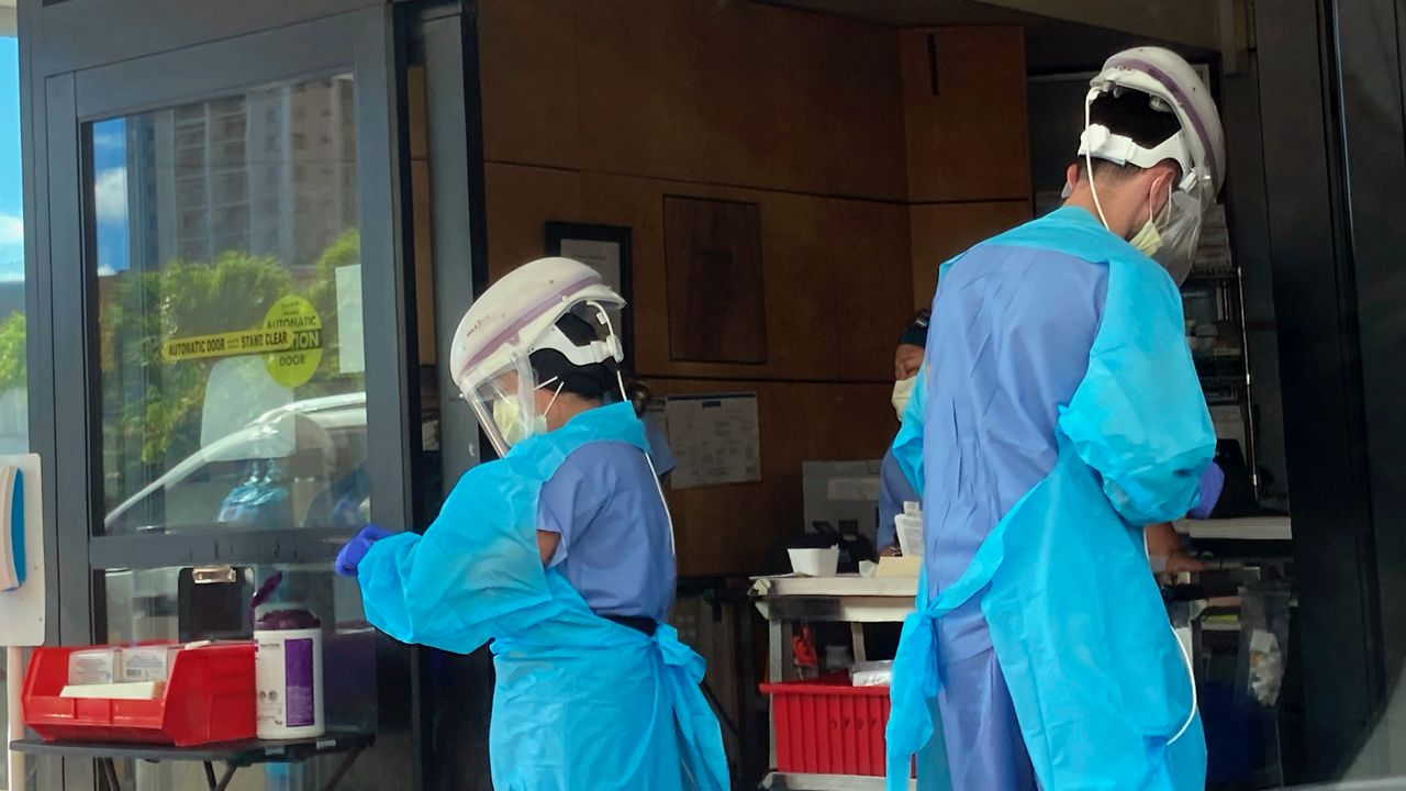 Hospital workers process COVID-19 tests at a hospital in Aiea, Hawaii, Wednesday, Sept. 15, 2021. (AP Photo/Caleb Jones, File)