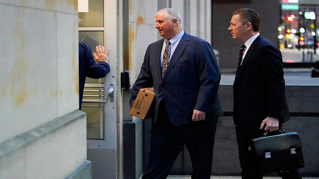 Former Ohio House Speaker Larry Householder, center, walks into Potter Stewart U.S. Courthouse with his attorneys, Mark Marein, left, and Steven Bradley, right, before jury selection in his federal trial, Friday, Jan. 20, 2023, in Cincinnati. (AP Photo/Joshua A. Bickel)