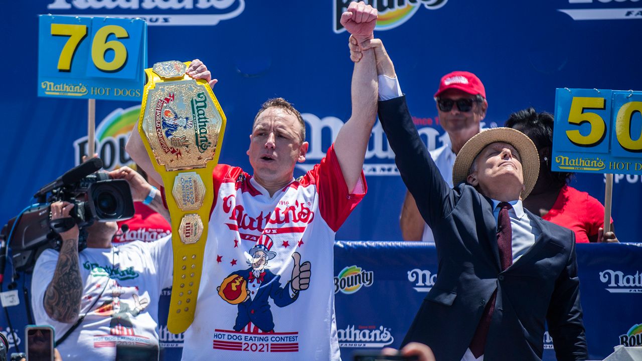 Chowdown champ Joey “Jaws” Chestnut celebrates after winning the the Nathan's Famous Fourth of July International Hot Dog-Eating Contest in Coney Island's Maimonides Park on Sunday, July 4, 2021. (AP Photo/Brittainy Newman)