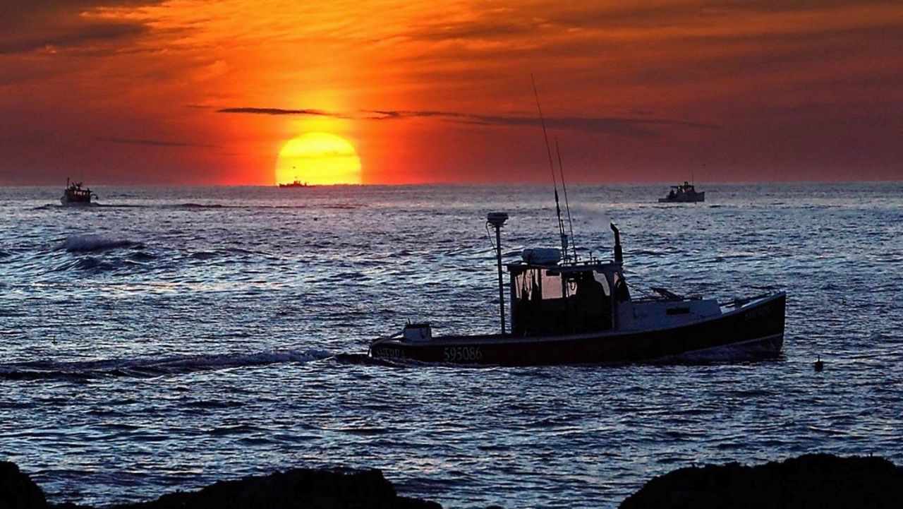 Lobster fishermen work at sunrise, Thursday, Sept. 8, 2022, off Kennebunkport, Maine. The waters off New England logged the second-warmest year in their recorded history in 2022, according to researchers. The Gulf of Maine, a body of water about the size of Indiana that touches Maine, New Hampshire, Massachusetts and Canada, is warming faster than the vast majority of the world's oceans. Scientists with Gulf of Maine Research Institute say 2022 fell short of setting a new high mark for hottest year in record by less than half a degree Fahrenheit. (AP Photo/Robert F. Bukaty, File)