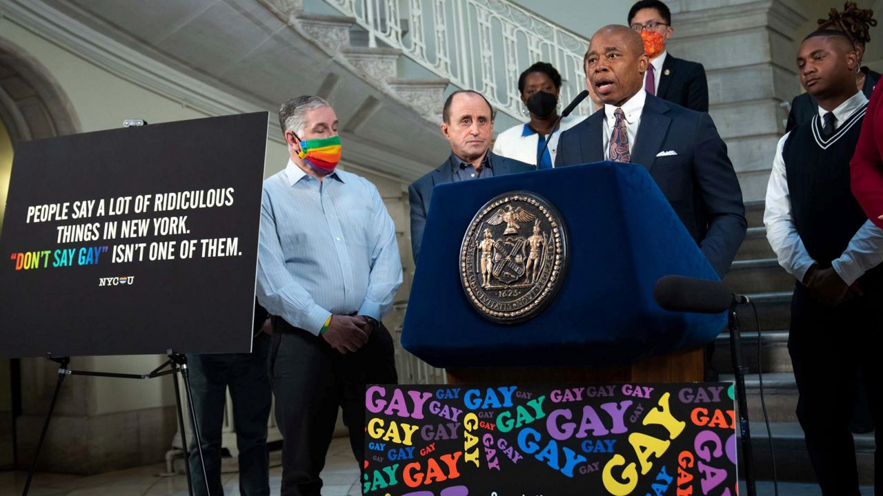 New York Mayor Eric Adams, at podium, addresses a news conference in the rotunda of City Hall, in New York, Monday, April 4, 2022. New York City is launching a digital billboard campaign, supporting LGBTQ visibility that will be displayed in five major markets in Florida for eight weeks, to lure Floridians unhappy with a new law to NYC. (Ed Reed/Office of the New York City Mayor via AP)