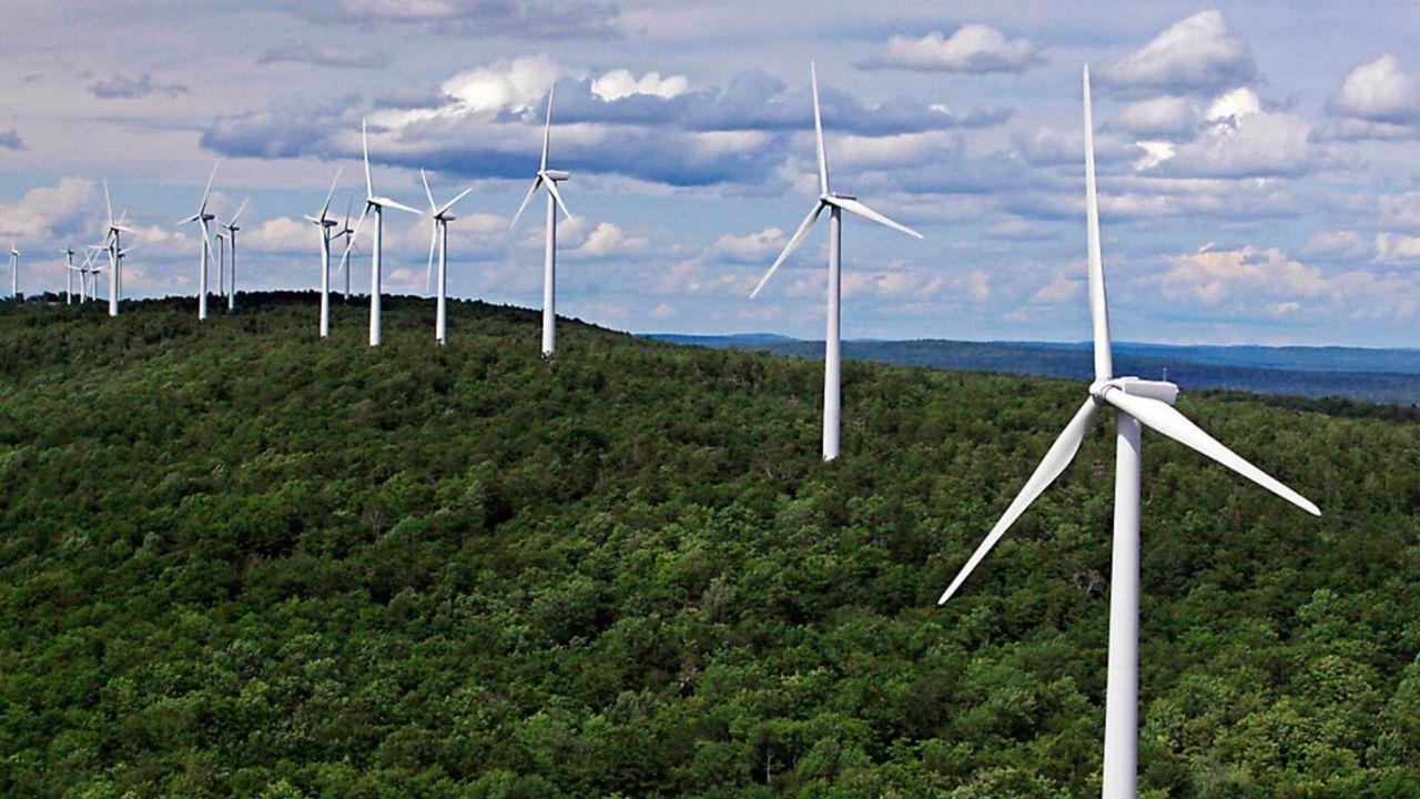 FILE - Wind turbines line a ridge on Stetson Mountain, July 14, 2009, in Washington County, Maine. Massachusetts and Maine are collaborating on a plan to finance an inland wind power project in far northern Maine. (AP Photo/Robert F. Bukaty, File)