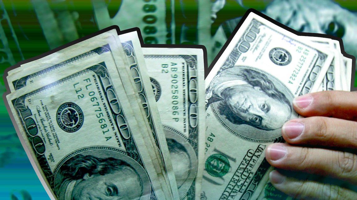 Handful of cash. (AP Images)