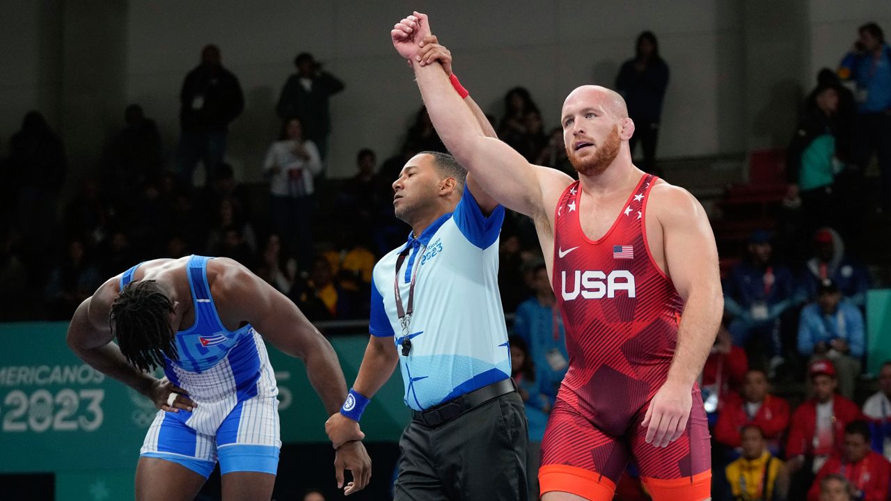 United States' Kyle Snyder, right, celebrates after winning gold against Cuba's Arturo Silot, left, during the men's 97kg wrestling freestyle final bout at the Pan American Games Santiago, Chile, Wednesday, Nov. 1, 2023.