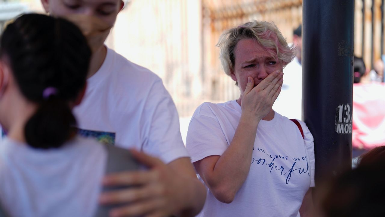 Irina Zolkina, who is seeking asylum in the United States, cries as she recalls her trip from Russia to the Mexican border. (AP Photo/Gregory Bull)
