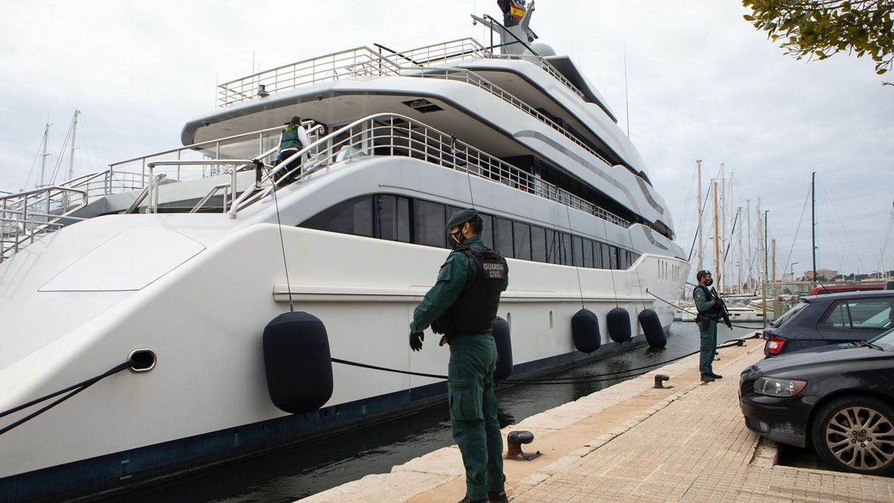 Civil Guards stand by the yacht called Tango in Palma de Mallorca, Spain, Monday April 4, 2022. The United States and allies are again escalating sanctions against Russia, Wednesday, April 6, after evidence that Russian troops murdered Ukrainian civilians in a town near Kyiv. (AP Photo/Francisco Ubilla, File)