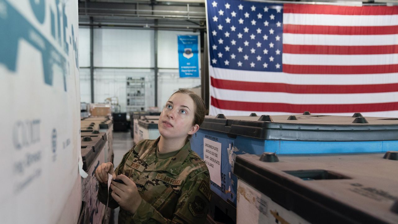 U.S. Air Force Airman Megan Konsmo checks pallets of equipment ultimately bound for Ukraine at Dover Air Force Base, Del. (AP Photo/Alex Brandon)