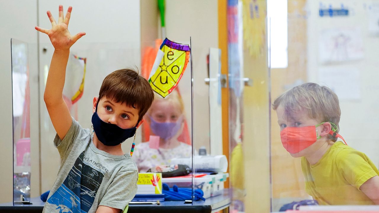 Young students wear masks in a classroom. (AP)