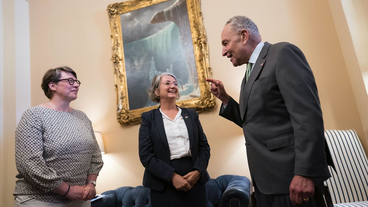 Senate Majority Leader Chuck Schumer, D-N.Y., right, welcomes Paivi Nevala, minister counselor of the Finnish Embassy, left, and Karin Olofsdotter, Sweden's ambassador to the U.S., center, just before the Senate vote to ratify NATO membership for the two nations in response to Russia's invasion of Ukraine, at the Capitol in Washington, Wednesday, Aug. 3, 2022. (AP Photo/J. Scott Applewhite)