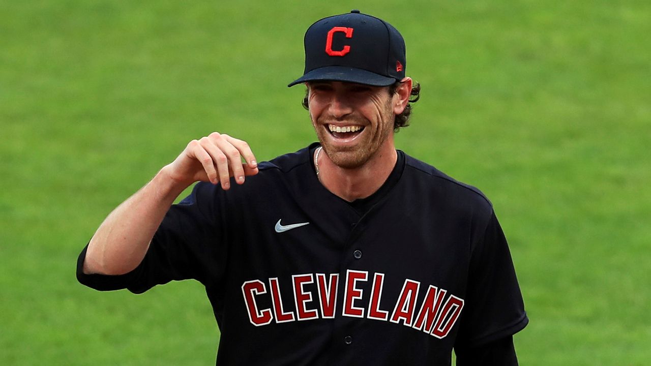Cleveland Indians' Shane Bieber (57) reacts between innings during a baseball game against the Cincinnati Reds in Cincinnati, on Aug. 4, 2020. The 2020 Cy Young winner, who was limited to just 16 starts last season due to a right shoulder strain, said Tuesday, March 15, 2022, that he remains open to signing a long-term contract extension with Cleveland. (AP Photo/Aaron Doster, File)