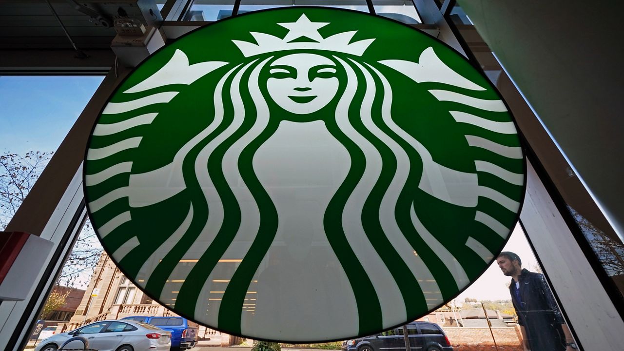 A Starbucks sign coffee shop in Pittsburgh. Starbucks says its U.S. workers must be fully vaccinated by Feb. 9 or face a weekly COVID testing requirement. (AP Photo/Gene J. Puskar)