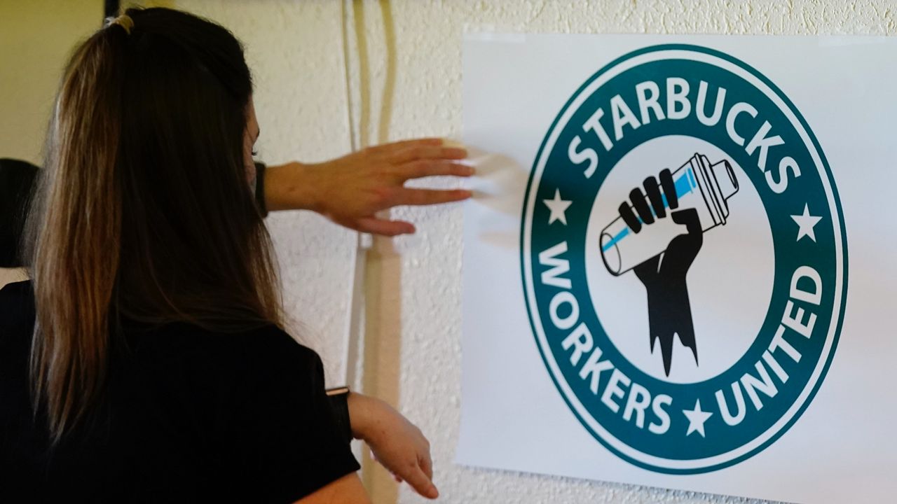 Michelle Eisen, a barista at the Buffalo, N.Y., Elmwood Starbucks location, helps out the local Starbucks Workers United, employees of a local Starbucks, as they gather at a local union hall. (AP Photo/Ross D. Franklin, File)