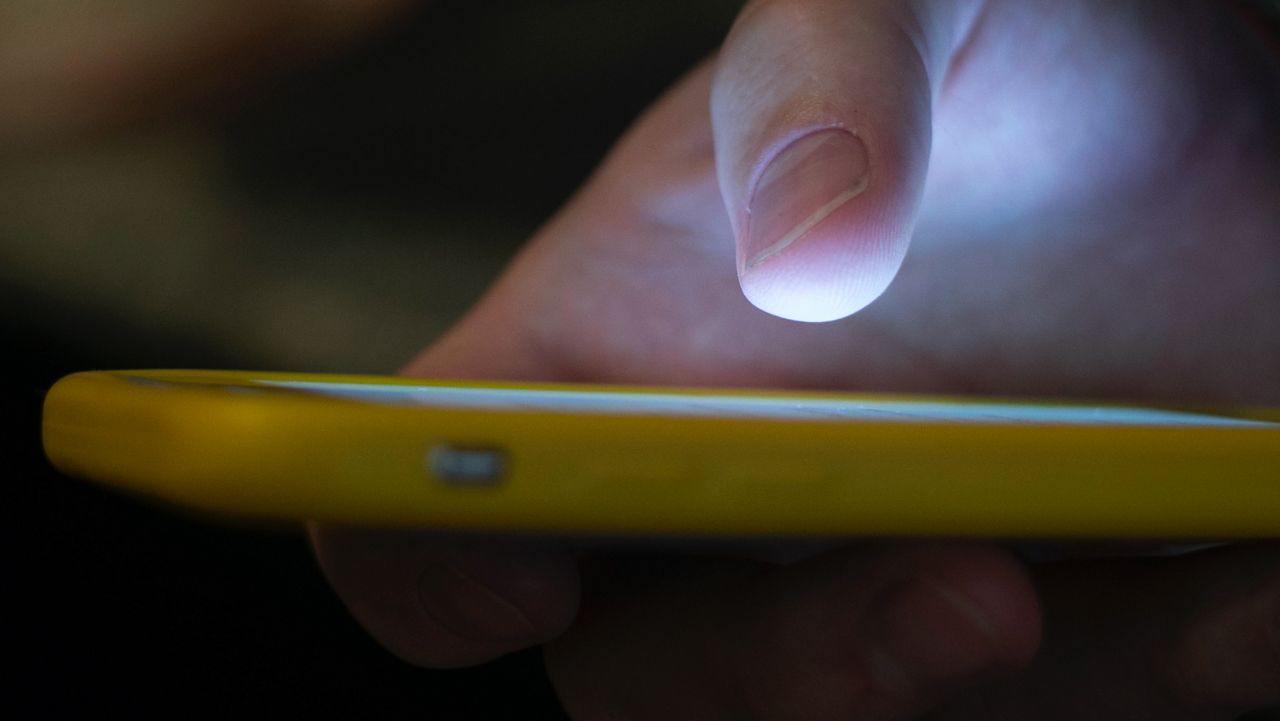 A person on a cell phone. (AP) 