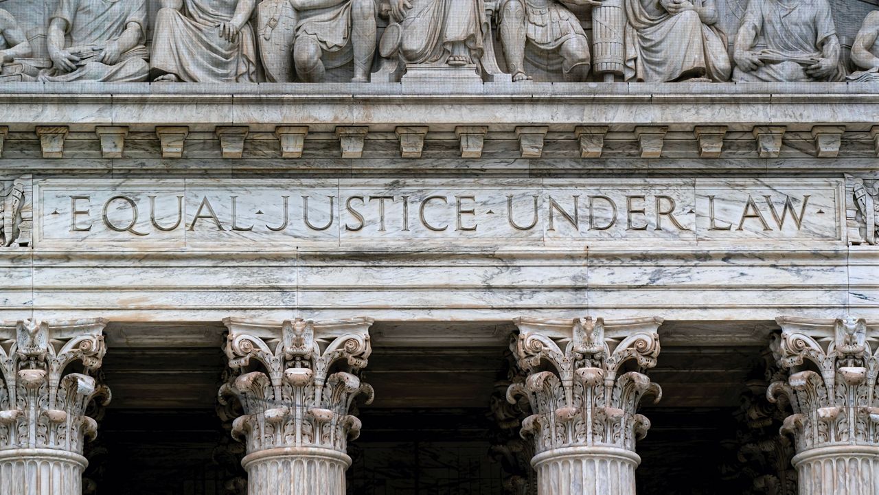 The Supreme Court Building is seen in Washington, Wednesday, May 4, 2022, as security measure are enhanced on the perimeter following protests sparked by news that the court might overturn cases that guarantee abortions. (AP Photo/J. Scott Applewhite)