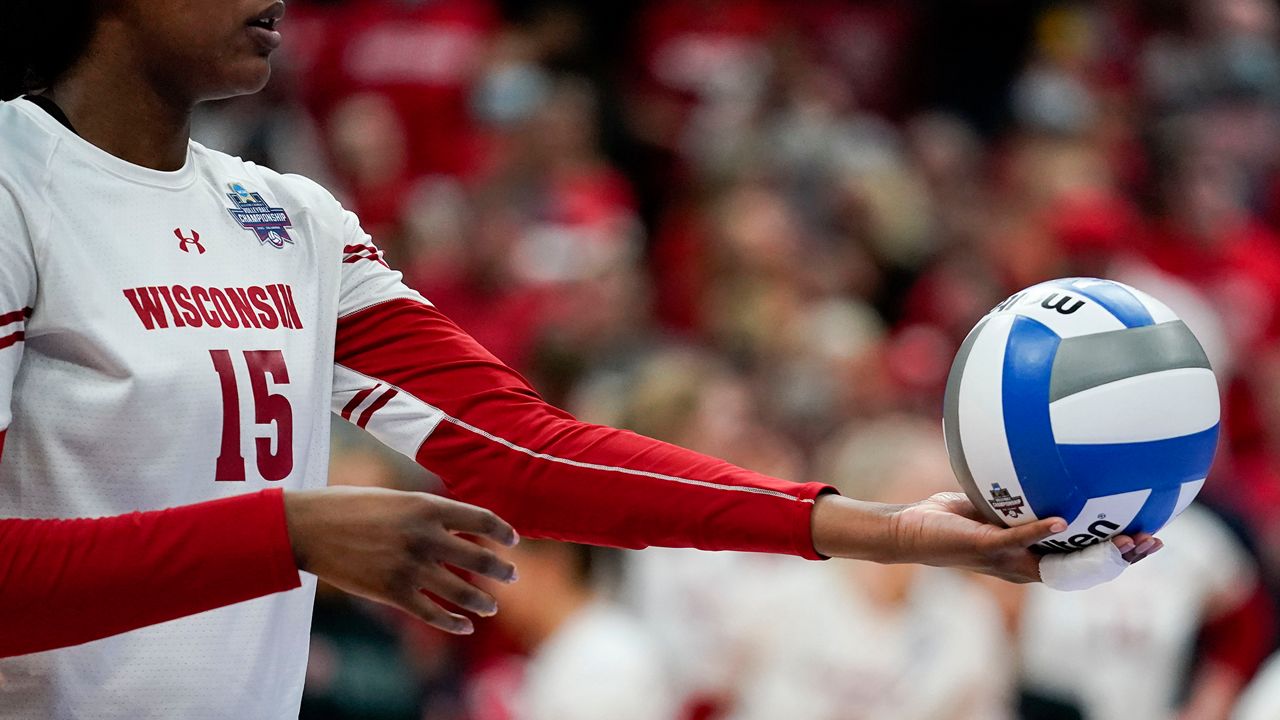 Wisconsin's Jade Demps (15) prepares to serve the ball during the championship match of the NCAA women's college volleyball tournament against Nebraska Saturday, Dec. 18, 2021, in Columbus, Ohio. (AP Photo/Jeff Dean)