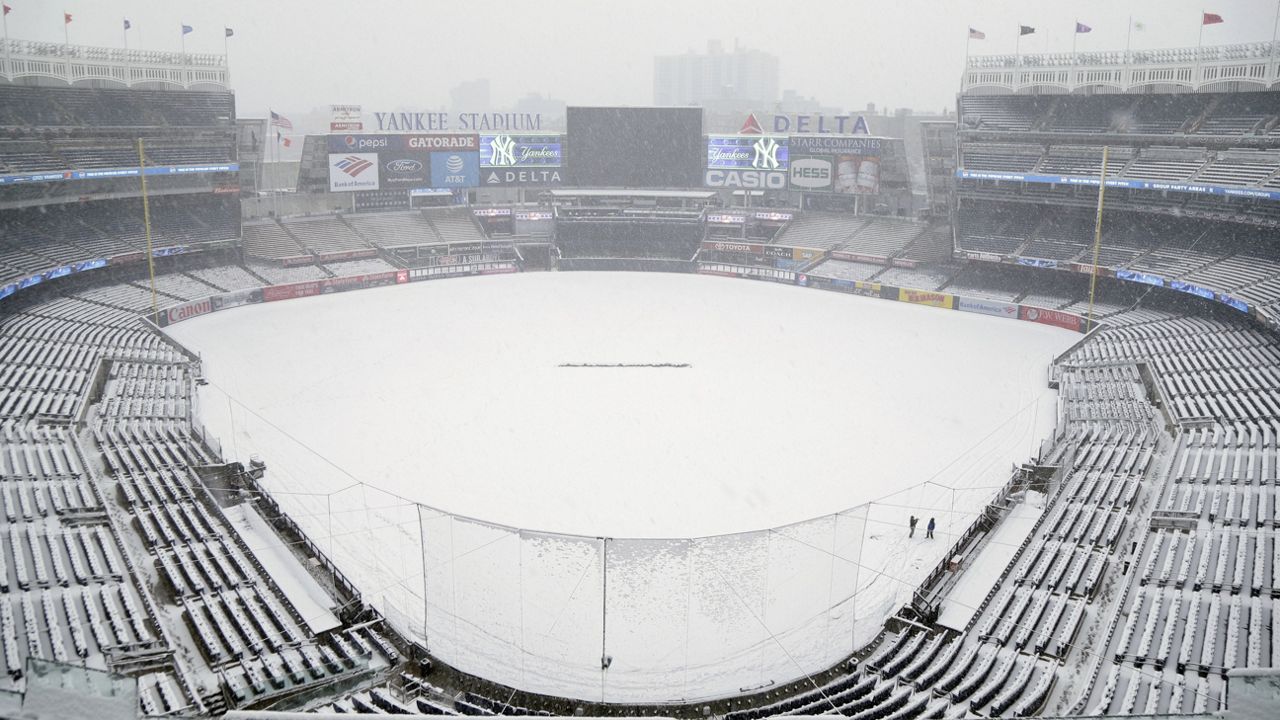 Snow blanketed on Yankee Stadium's field.