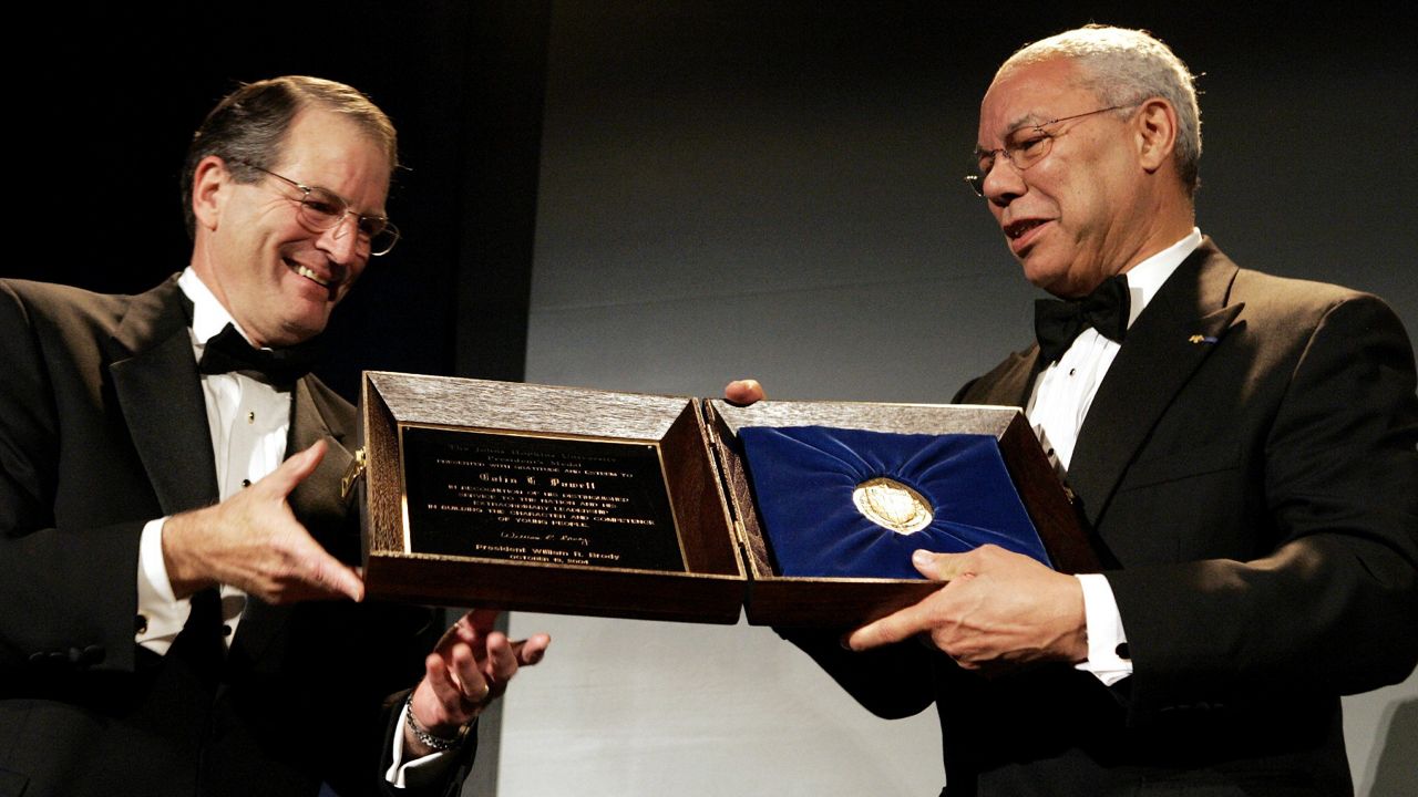 Secretary of State Colin Powell, right, receives the John Hopkins University President's Medal from John Hopkins President William Brody, left, on Wednesday, Oct. 13, 2004 in Washington. (AP Photo/Evan Vucci)