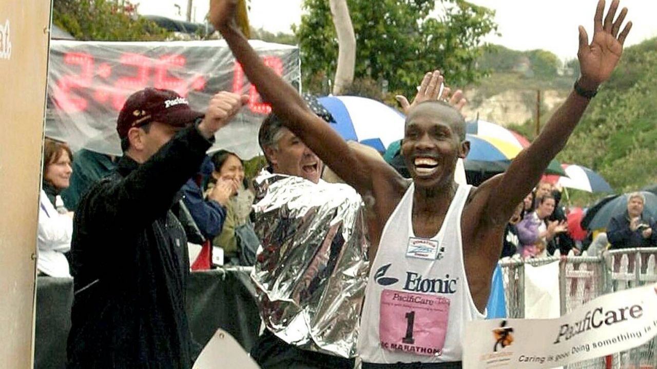In this handout photo provided by Denis Crew Photography, Andrew Masuva, 40, crosses the finish line during the Orange County Marathon, Dec. 5, 2004, in Newport Beach, Calif. (AP Photo/Denise Crew Photography)