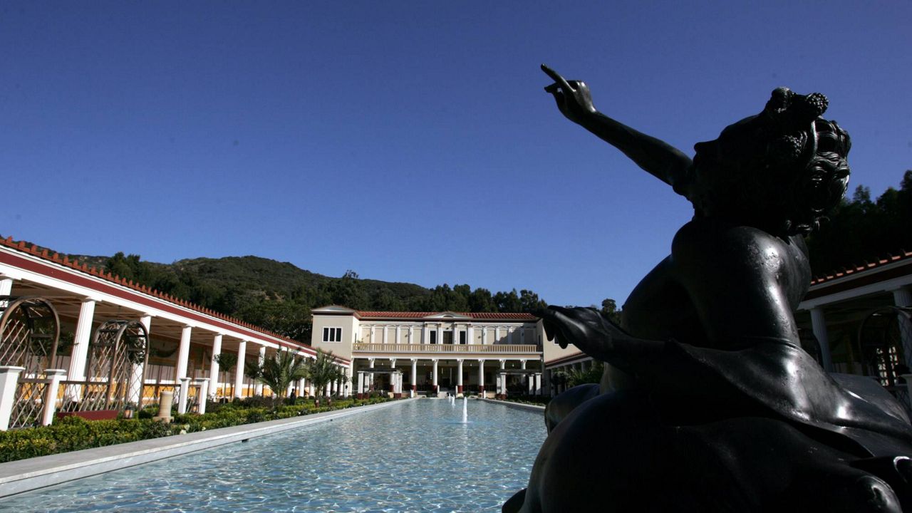 A replica depicting a drunken faun overlooks the garden pool at the Getty Villa in Los Angeles Tuesday, Jan. 24, 2006. (AP Photo/Stefano Paltera)