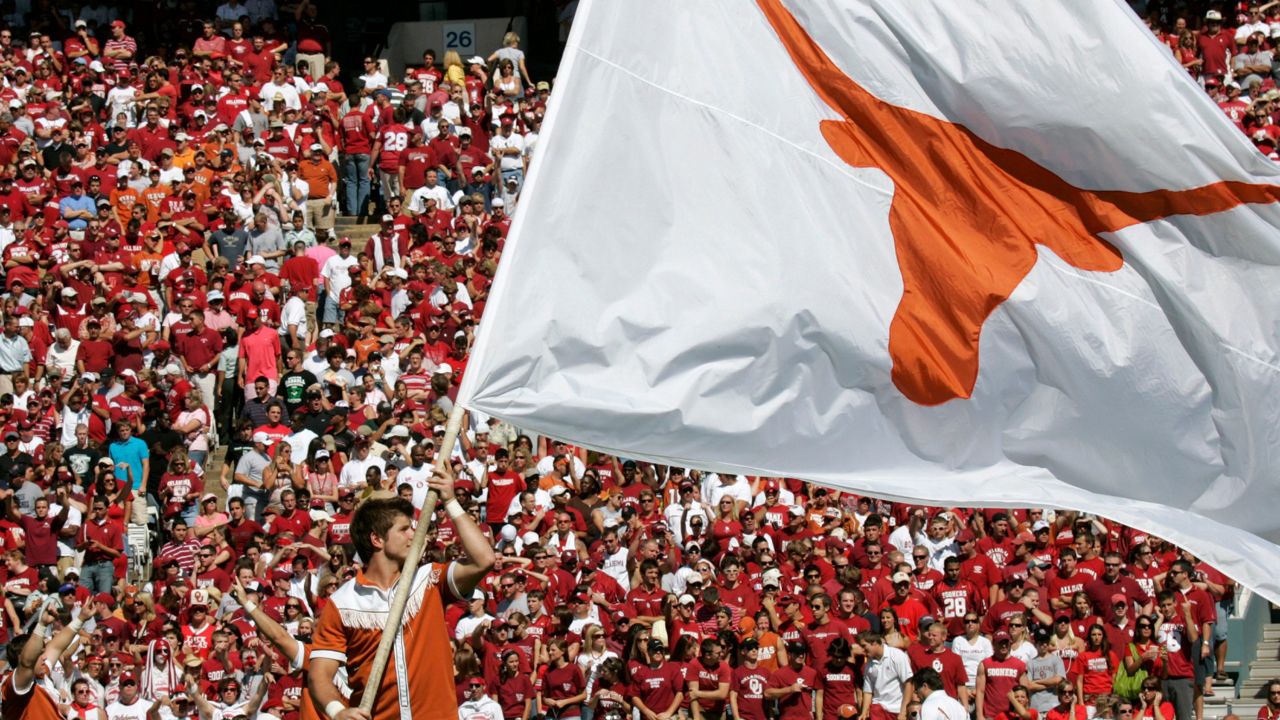 The Texas Longhorn flag is waved on the playing field before the annual Texas-Oklahoma in football game at the Cotton Bowl in Dallas, Saturday, Oct. 7, 2006. (AP Photo/Donna McWilliam)