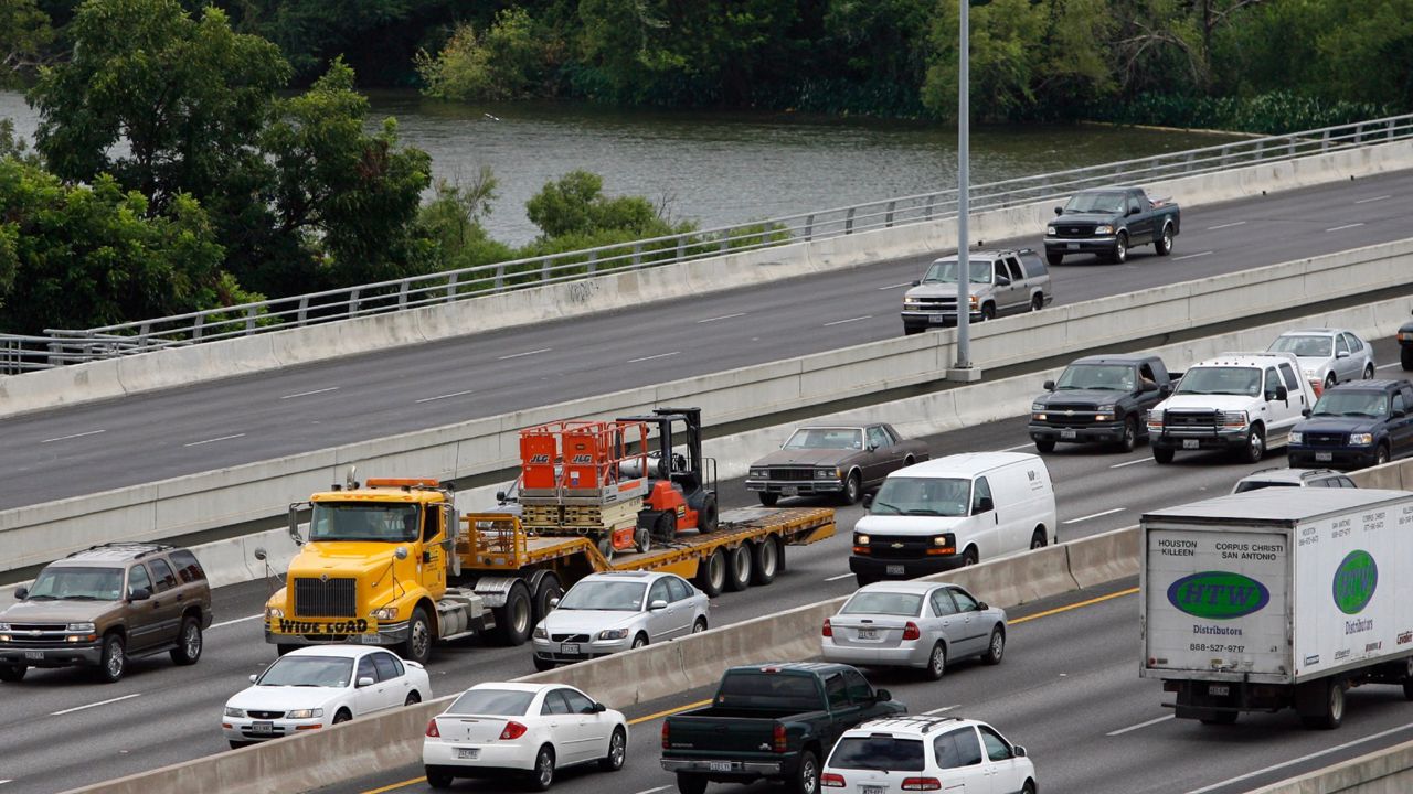 Vehicles cross the Interstate 35 bridge over Lady Bird Johnson Lake in this file image. (AP Photo/Harry Cabluck)