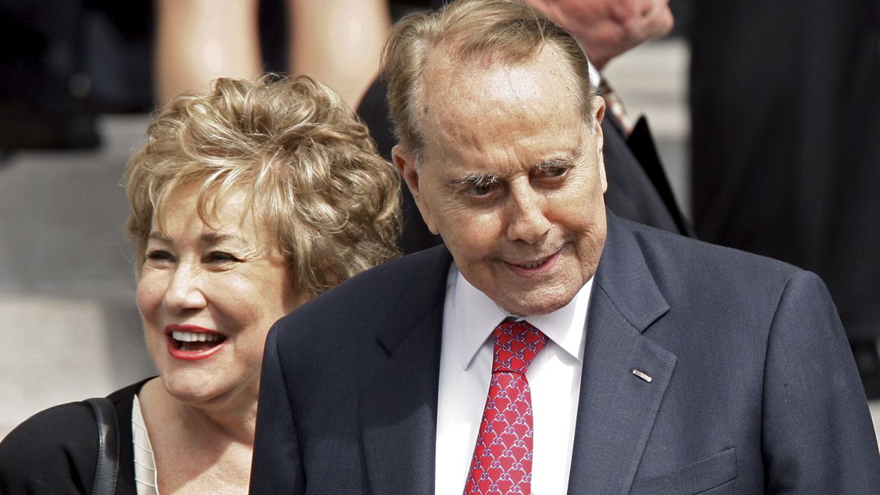 Former Sen. Bob Dole, R-Kan., and his wife, former Sen. Elizabeth Dole, R-NC, leave the memorial service for Jack Kemp at National Cathedral in Washington, Friday, May 8, 2009. (AP Photo/J. Scott Applewhite)
