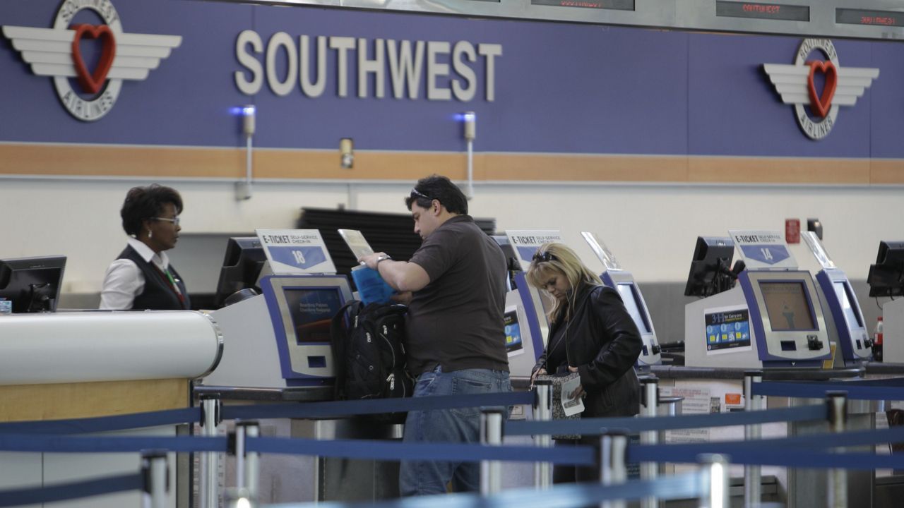 Customers at the Southwest Airlines counters at the Fort Lauderdale airport Thursday, Jan. 13, 2011. (AP Photo/J Pat Carter)