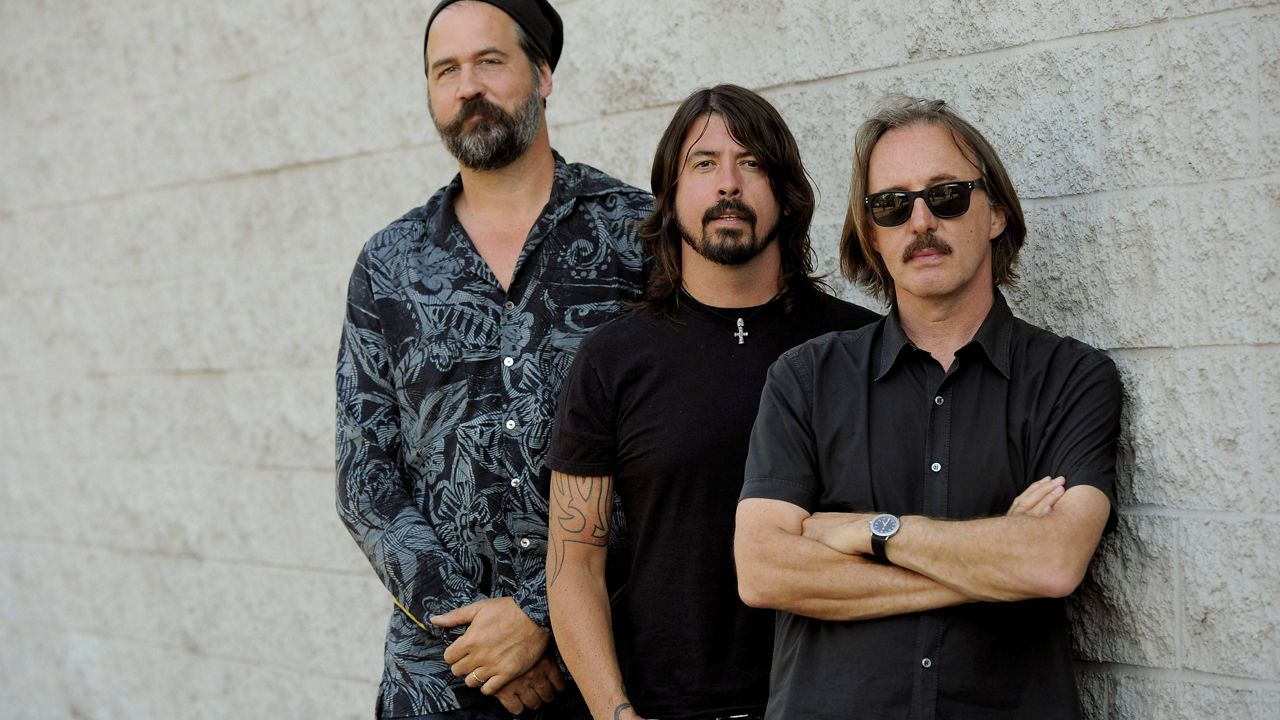 Krist Novoselic, left, and Dave Grohl, center, former members of the band Nirvana, pose with Butch Vig, producer of their landmark 1991 album "Nevermind," Tuesday, Sept. 6, 2011, in Los Angeles. A 20th anniversary edition of the album will be released on Sept. 27. (AP Photo/Chris Pizzello)