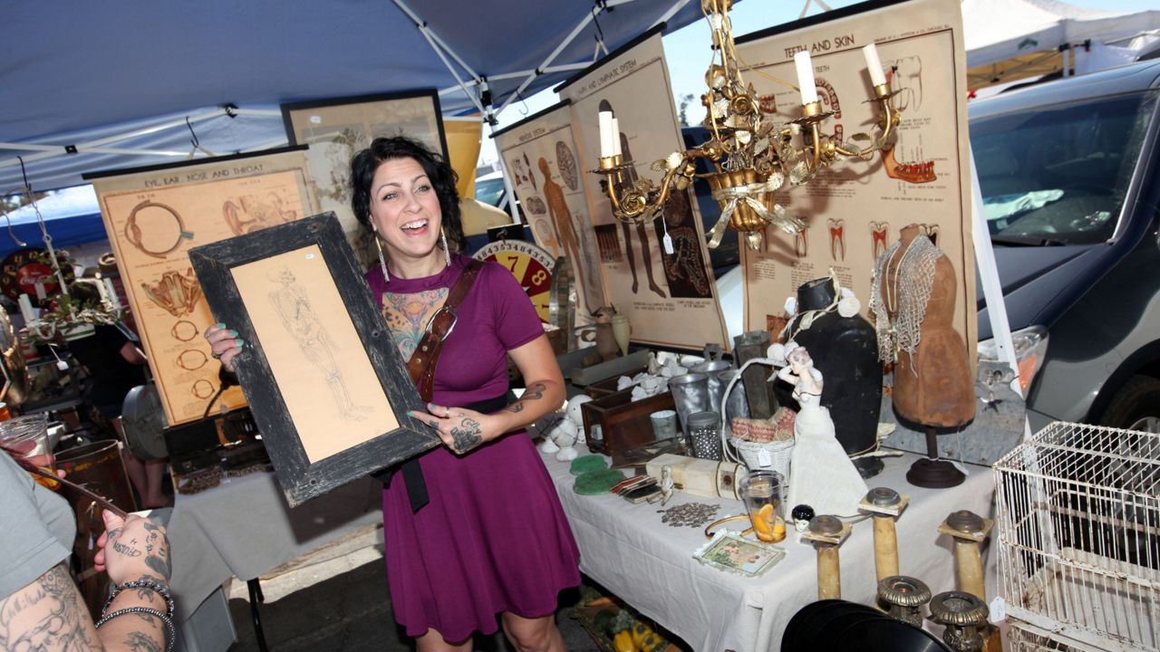 Danielle Colby from American Pickers with her “pick of the day” at the Rose Bowl Flea Market on Sunday, July 8, 2012 in Pasadena, Calif. (Photo by Casey Rodgers/Invision for History/AP Images)