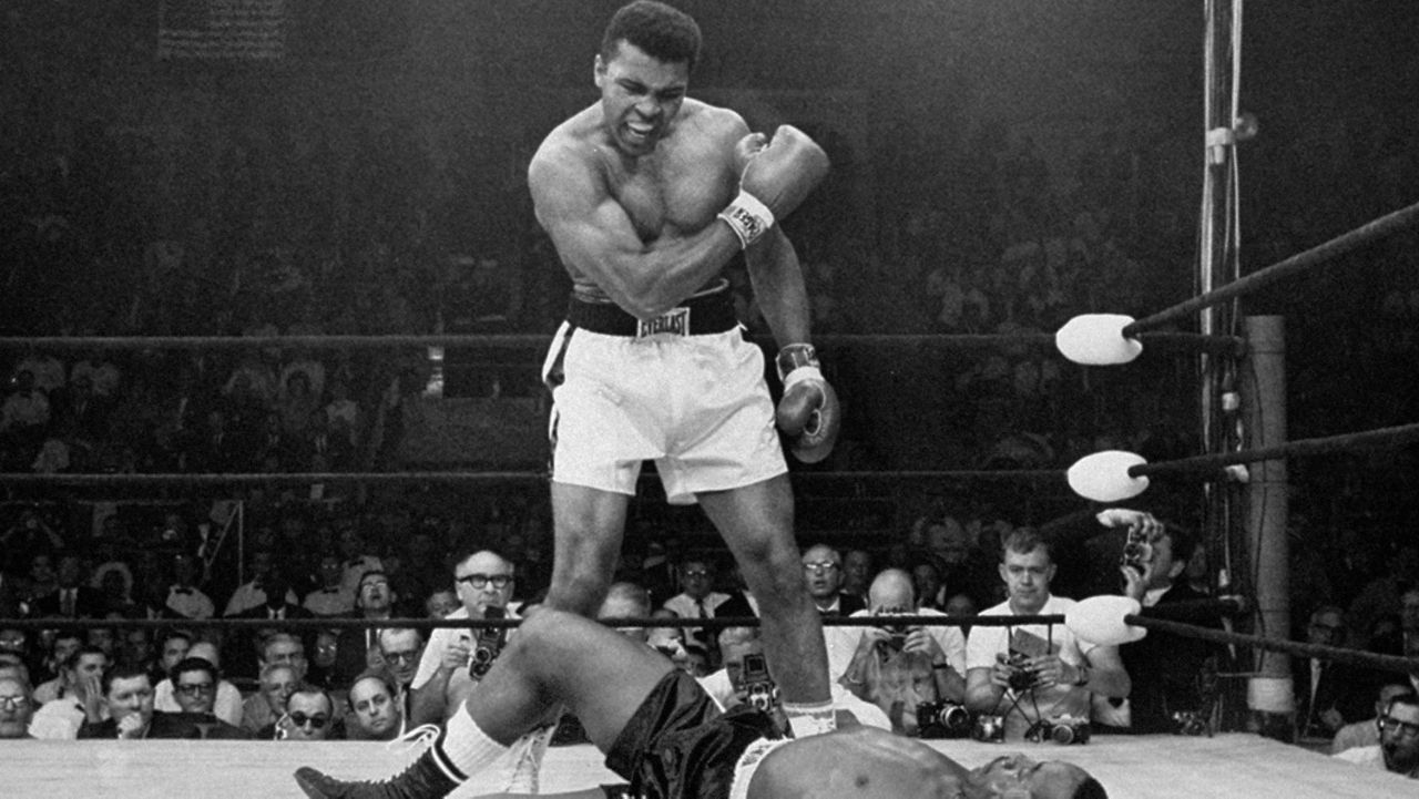 In this May 25, 1965, file photo, heavyweight champion Muhammad Ali stands over fallen challenger Sonny Liston shortly after dropping him with a short hard right to the jaw in Lewiston, Maine. (AP Photo/John Rooney, File)