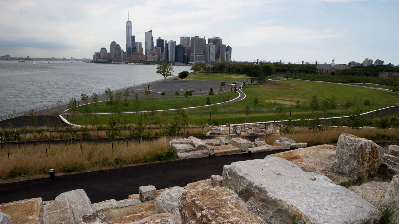 In this Wednesday, July 13, 2016, photo, giant granite scramble on Outlook Hill is seen on Governors Island in New York's harbor. Set to open July 19, the 10-acre park called The Hills at Governors Island is the newest piece of the redevelopment of the once off-limits former military base just off the tip of lower Manhattan.