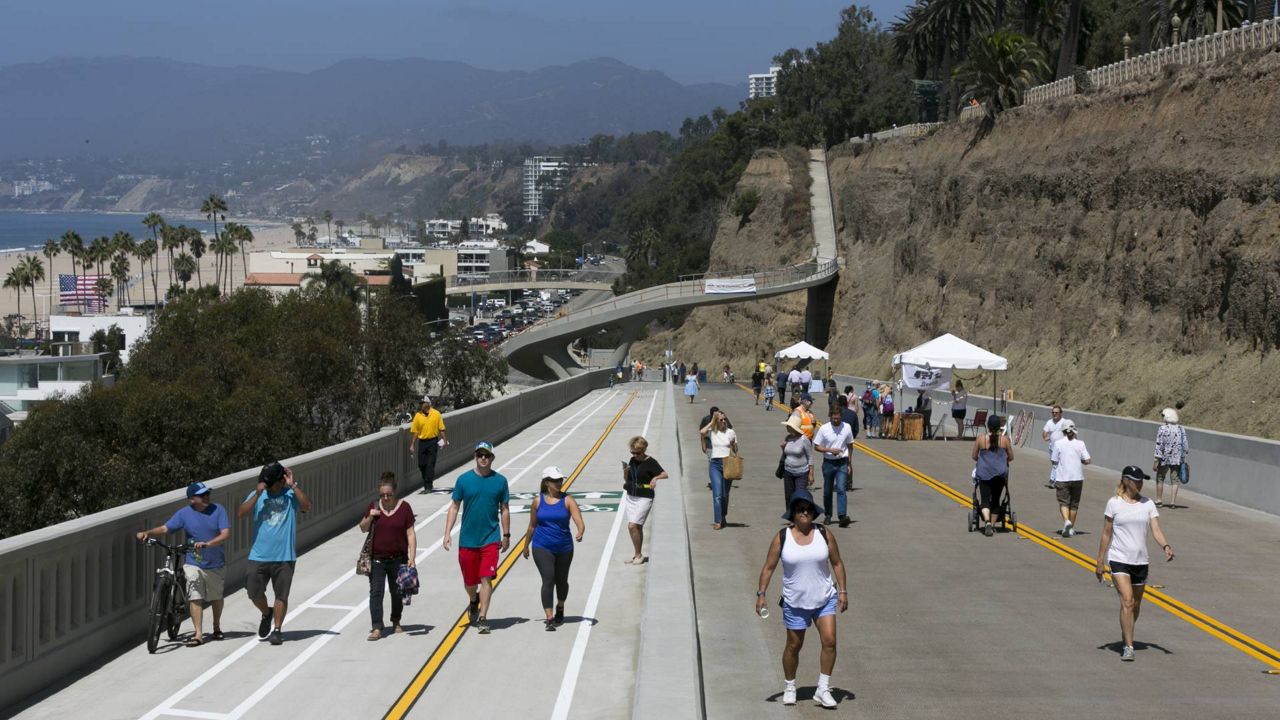 Pedestrians tour the California Incline, a 1,400-foot-long roadway dating back to the 1930s that connects the top of Santa Monica's Palisades bluffs with Pacific Coast Highway down below in Santa Monica, Calif., on Sep 1, 2016. (AP Photo/Damian Dovarganes)
