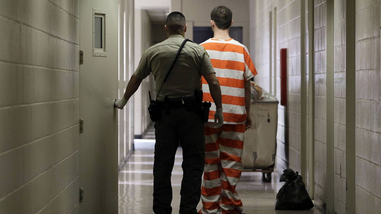 FILE - In this Feb. 21, 2013 photo, an inmate at the Madera County Jail is taken to a housing unit at the facility in Madera, Calif. (AP/Rich Pedroncelli)