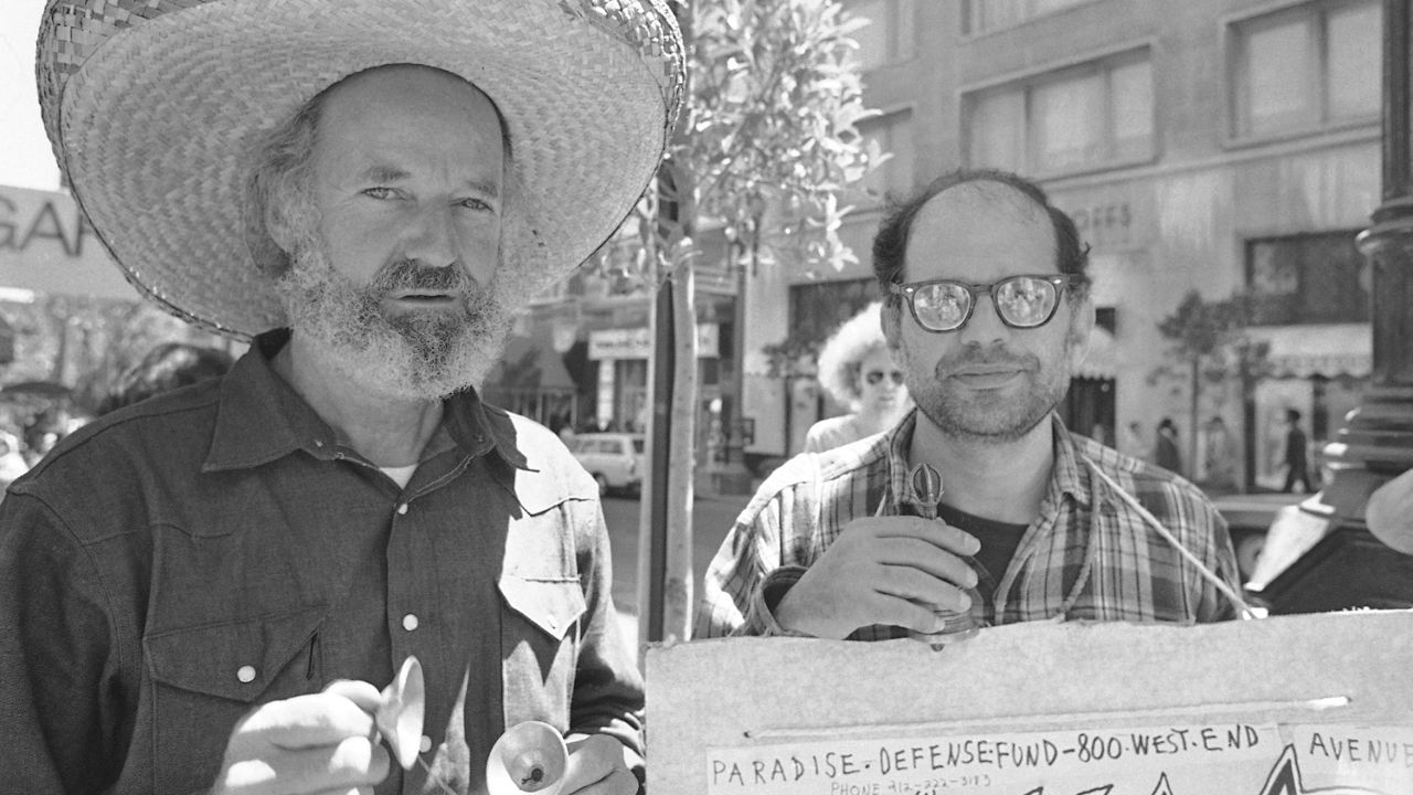 In this Aug. 11, 1971, file photo, Lawrence Ferlinghetti (left) and Allen Ginsburg join a picket line outside Varig Airlines in protest over theater people who had been arrested in Brazil. (AP Photo/Sal Veder, File)