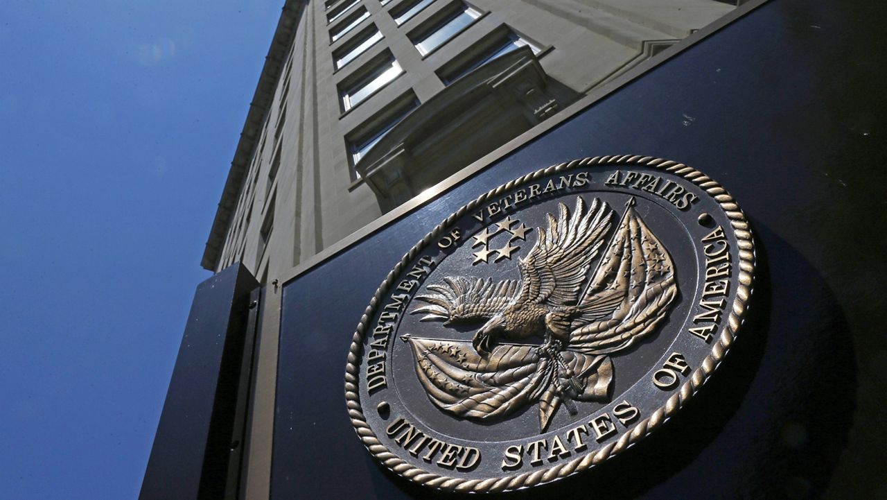 In this June 21, 2013, file photo, the seal affixed to the front of the Department of Veterans Affairs building in Washington. The Department of Veterans Affairs is warning of a rapidly growing backlog for veterans who seek to appeal decisions involving disability benefits, saying it will need much more staff even as money remains in question due to a tightening Trump administration budget. (AP Photo/Charles Dharapak, File)