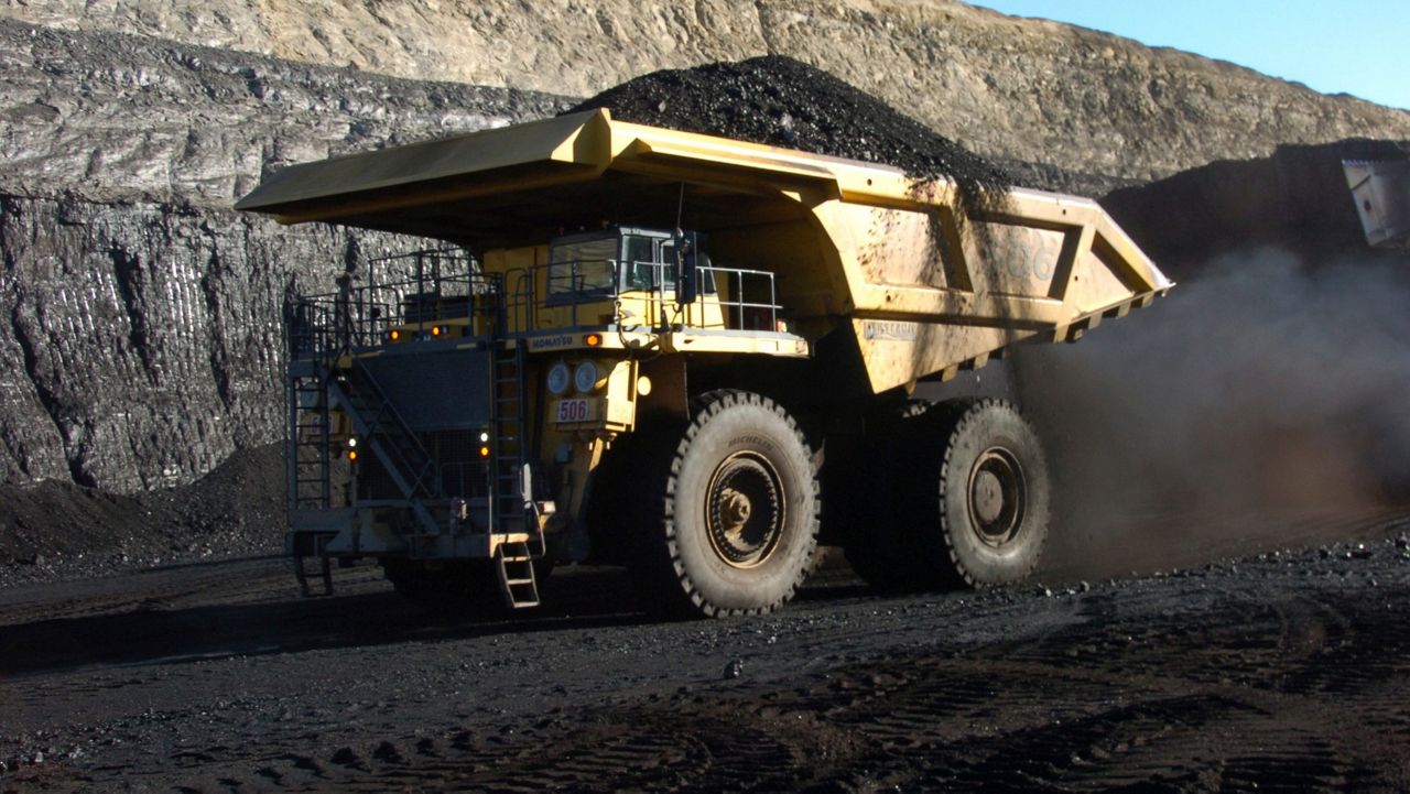 FILE - In this Nov. 15, 2016 file photo, a haul truck with a 250-ton capacity carries coal. (AP Photo/Matthew Brown, File)