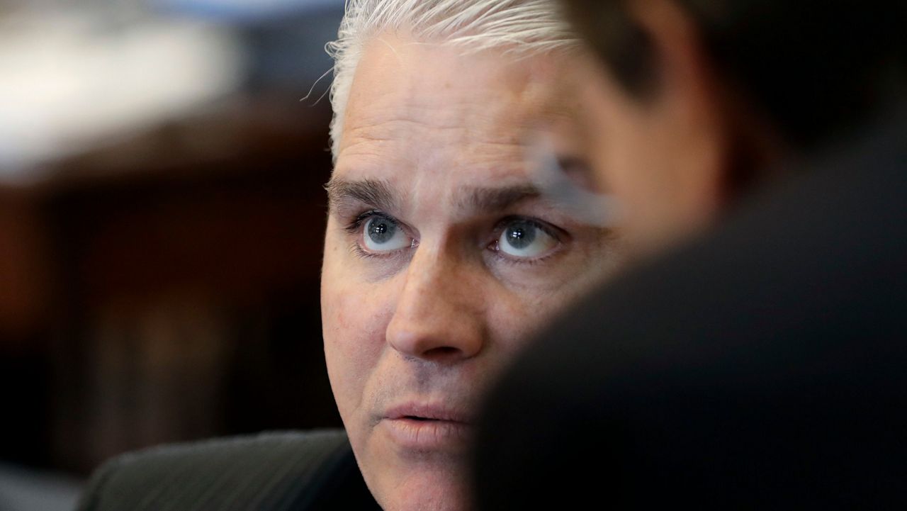 Rep. Dan Huberty, R-Houston, talks with fellow lawmakers on the House floor Wednesday, April 19, 2017, in Austin, Texas. (AP Photo/Eric Gay) 