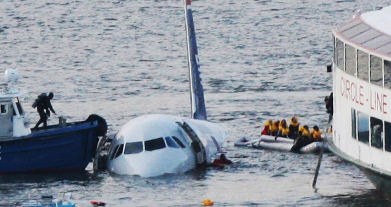 FILE - In this Jan. 15, 2009 file photo, a diver, left, aboard an NYPD vessel prepares to rescue passengers that escaped from the Airbus 320 US Airways aircraft made an emergency landing in the Hudson River in New York in what came to be known as the 