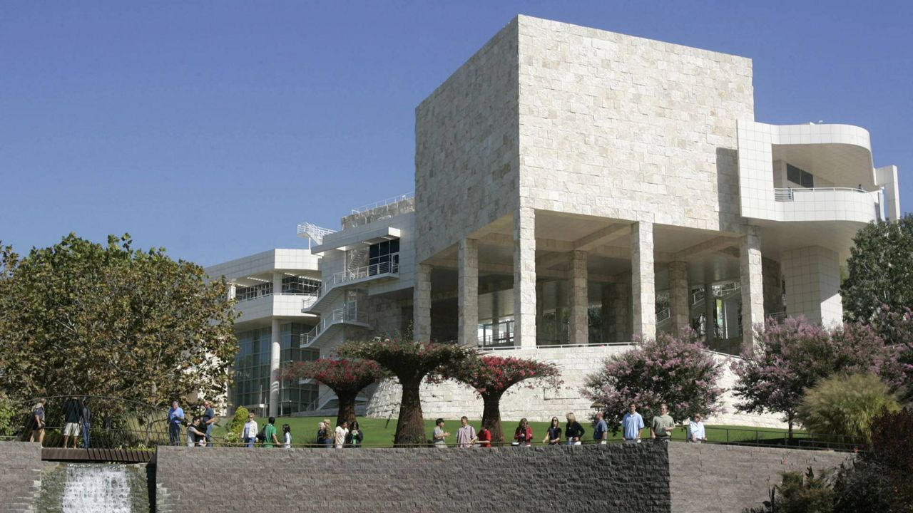 In this Oct. 9, 2005 file photo, visitors walk in the gardens at the J. Paul Getty Museum in Los Angeles. (AP Photo/Ric Francis)