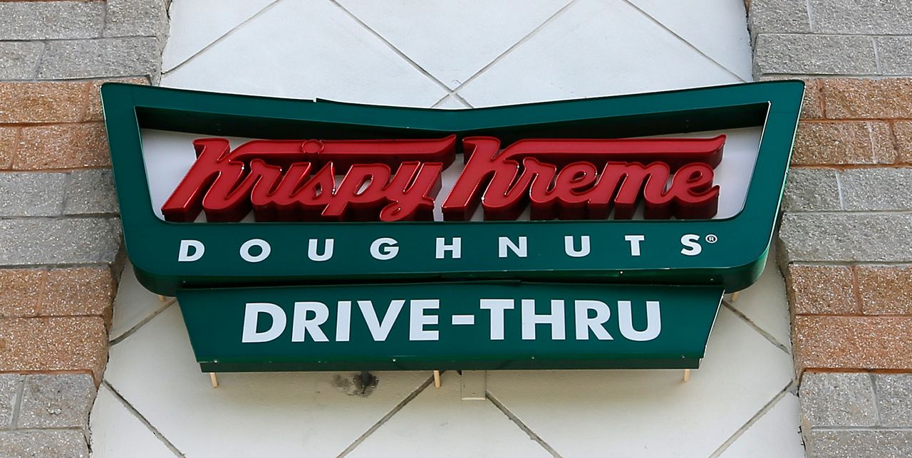This photo taken Friday, Aug. 11, 2017, shows Krispy Kreme Doughnuts sign in Miami. (AP Photo/Alan Diaz)