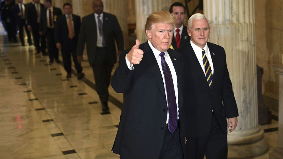 President Donald Trump gives a thumbs up as he walks with Vice President Mike Pence as he departs Capitol Hill in Washington, Thursday, Nov. 16, 2017. Trump urged House Republicans Thursday to approve a near $1.5 trillion tax overhaul as the party prepared to drive the measure through the House. Across the Capitol, Democrats pointed to new numbers showing the Senate version of the plan would boost taxes on lower and middle-income Americans. (AP Photo/Susan Walsh)