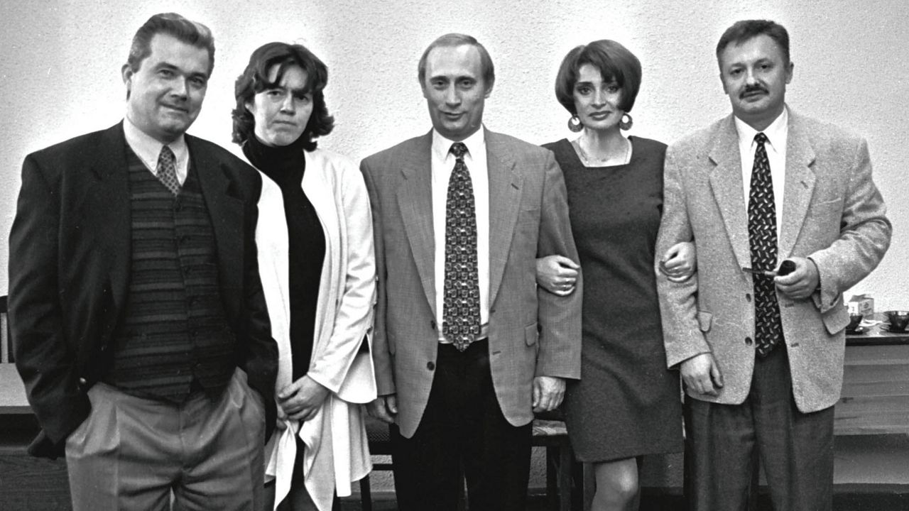 FILE- Vladimir Putin, then-Russian President Boris Yeltsin's deputy chief of staff, center, poses with his friends at a party in St.Petersburg, in this February, 1997 file photo. (AP Photo/Dmitri Lovetsky, File)