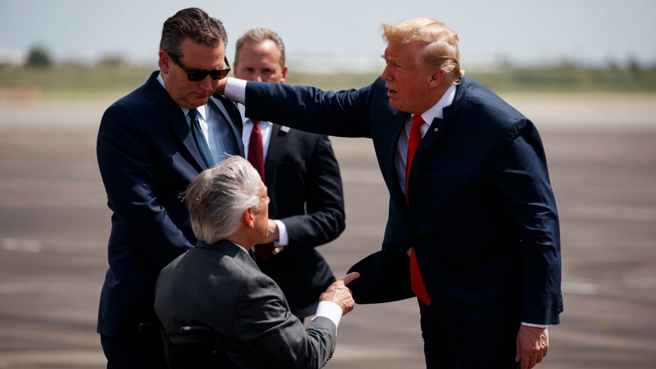 President Donald Trump talks with Sen. Ted Cruz, R-Texas, left, and Gov. Greg Abbott, R-Texas, after arriving at Ellington Field Joint Reserve Base, Thursday, May 31, 2018, in Houston. (AP Photo/Evan Vucci)