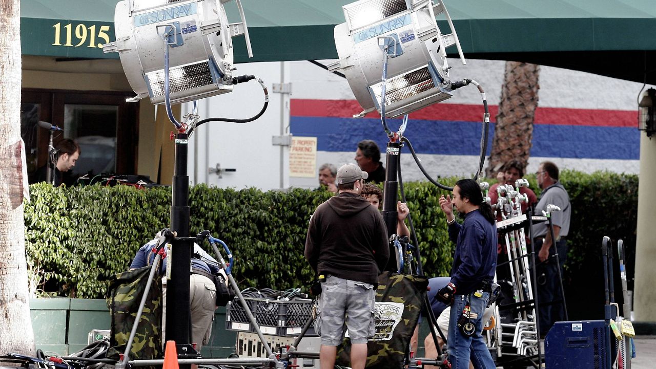  In this Nov. 5, 2007, file photo, production crew members work on a film set along Ventura Blvd., near to CBS Studios in the Studio City section of Los Angeles.