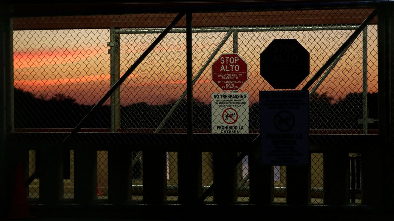 Fencing, gates and signs are seen on the Progreso-Nuevo Progreso International Bridge, Thursday, Nov. 1, 2018, in Progreso, Texas. (AP Photo/Eric Gay)